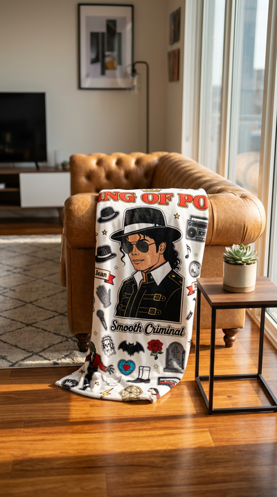 King of Pop Coloring Blanket full color draped over tan leather sofa