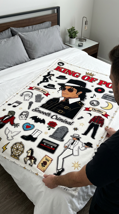 Hands spreading King of Pop full color blanket across white bed
