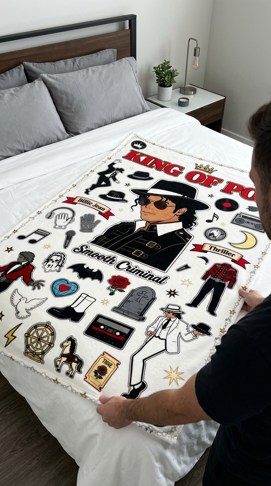 Hands spreading King of Pop full color blanket across white bed